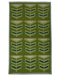 A pterapod grass area rug with a retro geometric pattern of stylized chevron leaves in olive green, light green, teal blue, and cream, finished with a light blue border.