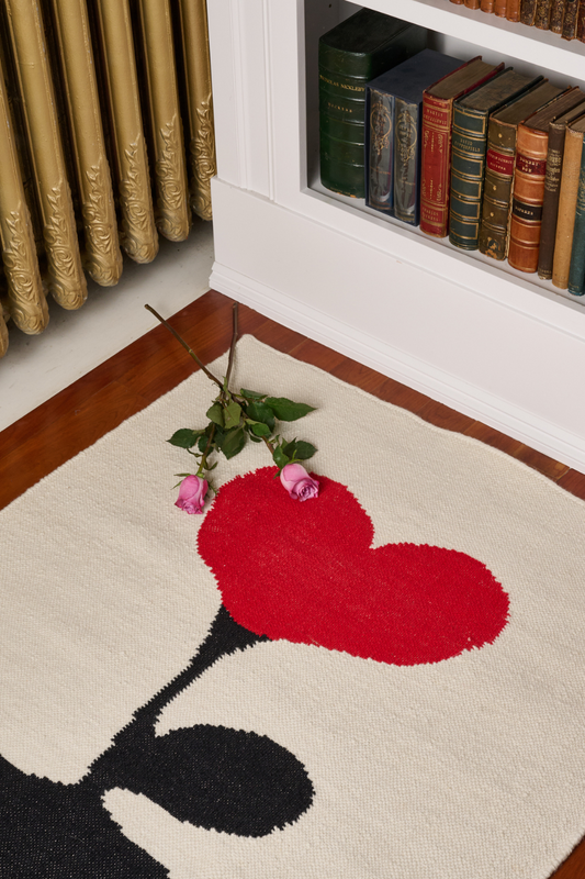 Love Blossom Crush wool area rug by Angela Adams in graphic black with a blossom