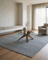 aa x Chilton Design 3 Colorway A area rug in a modern living room with neutral furniture and a glass coffee table.