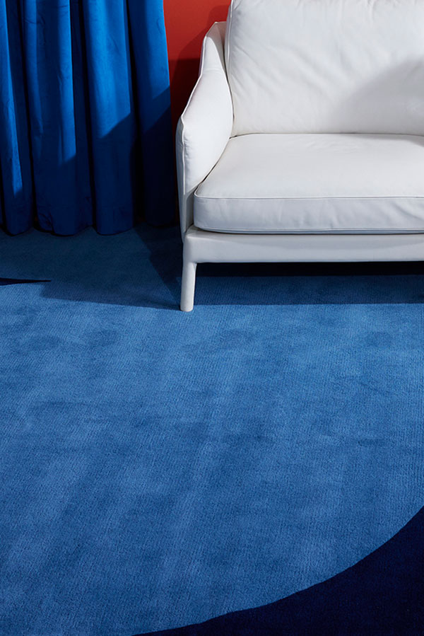 A blue and dark blue, hand tufted area rug called, Dove Midnight by Angela Adams