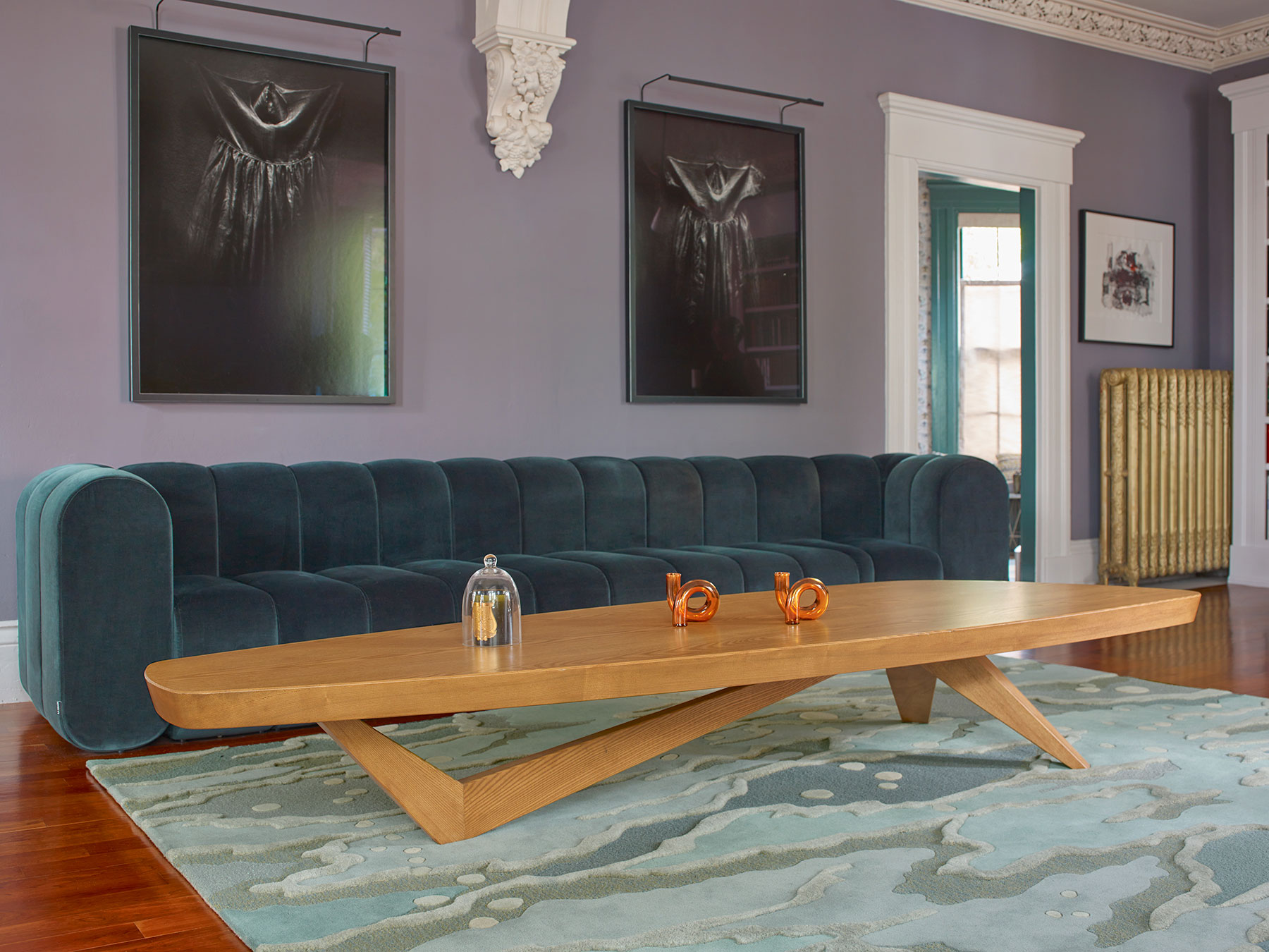 A contemporary living room in purple walls and wood table on an Angela Adams Ocean Rug