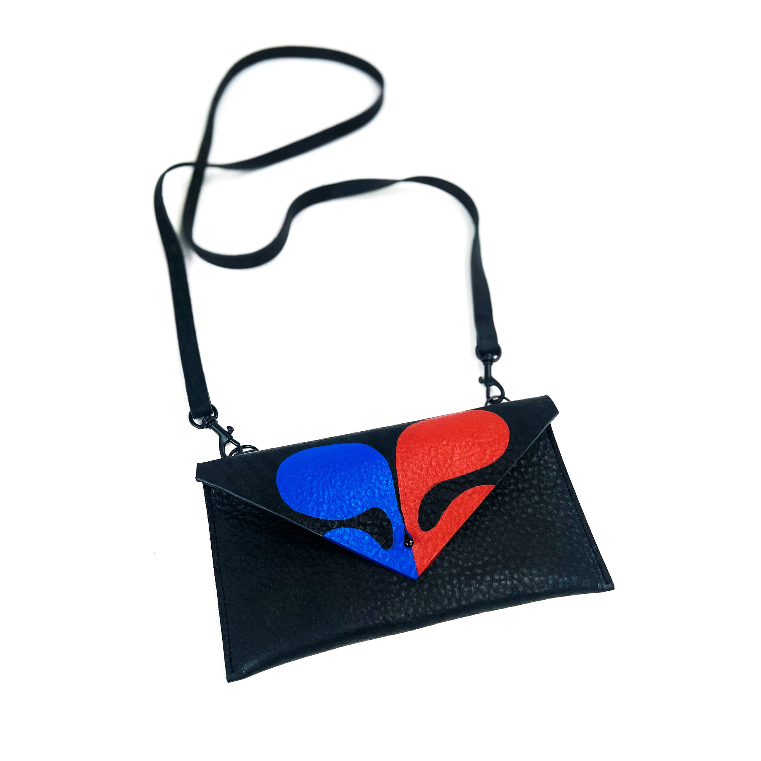 A black leather shoulder bag with a sparkling red and blue heart design, isolated on a white background.