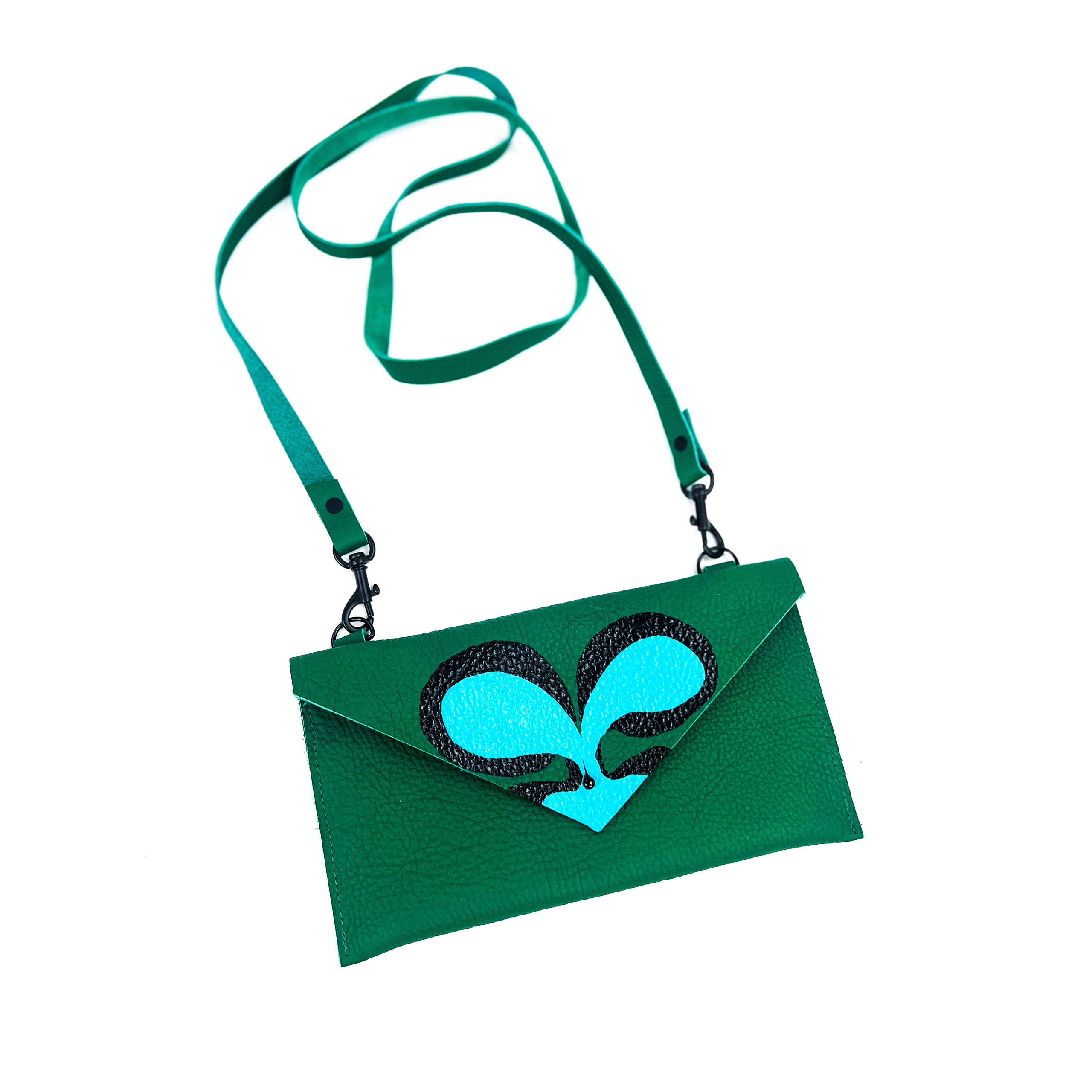 A teal green leather shoulder bag with a sparkling blue heart design, isolated on a white background.