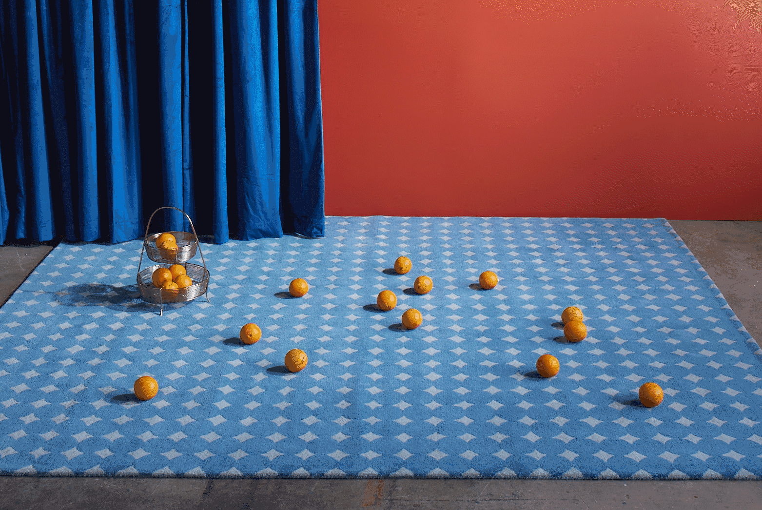 An animated Bongo Pool blue modern rug with dancing oranges hopping into the basket