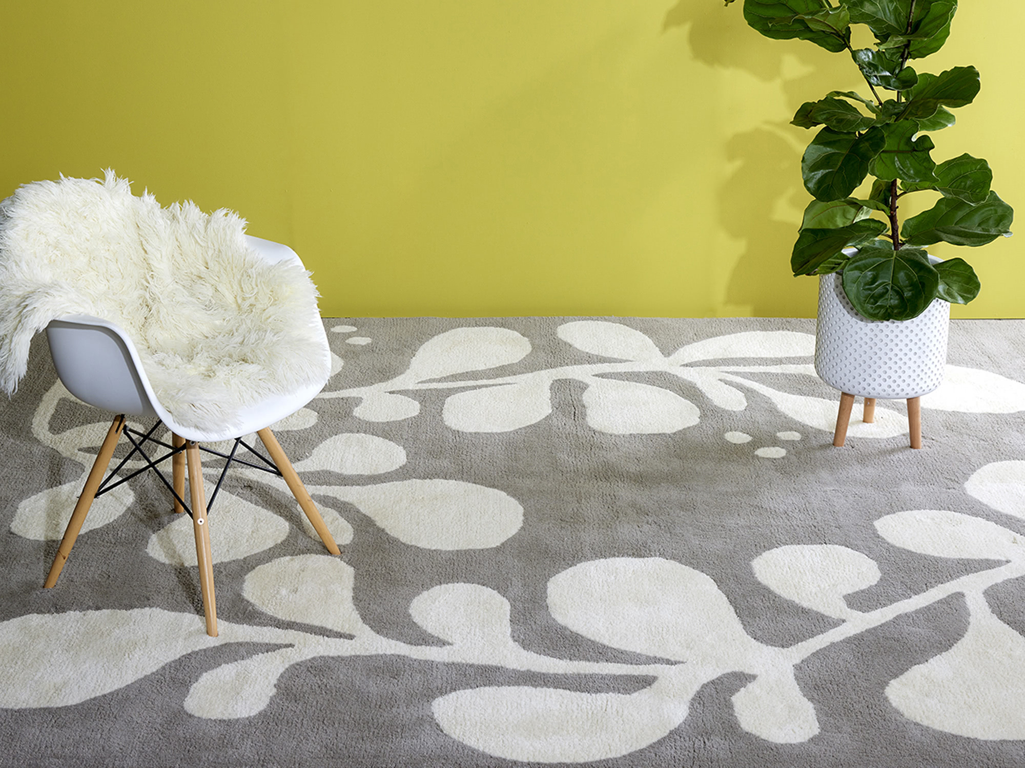 A gray and white vine patterned rug by angela adams