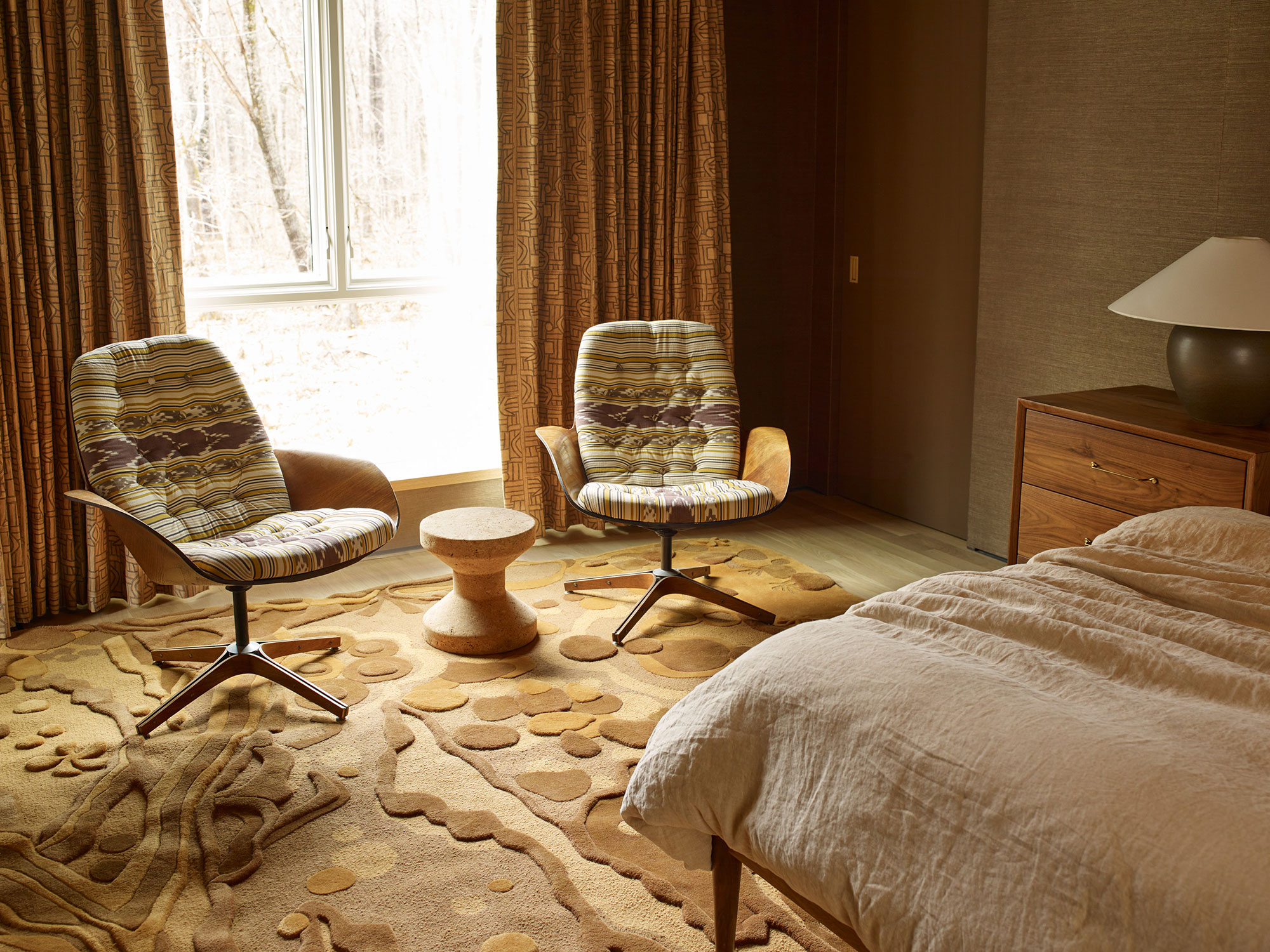 A soft brown and tan rug by Angela Adams in a living room
