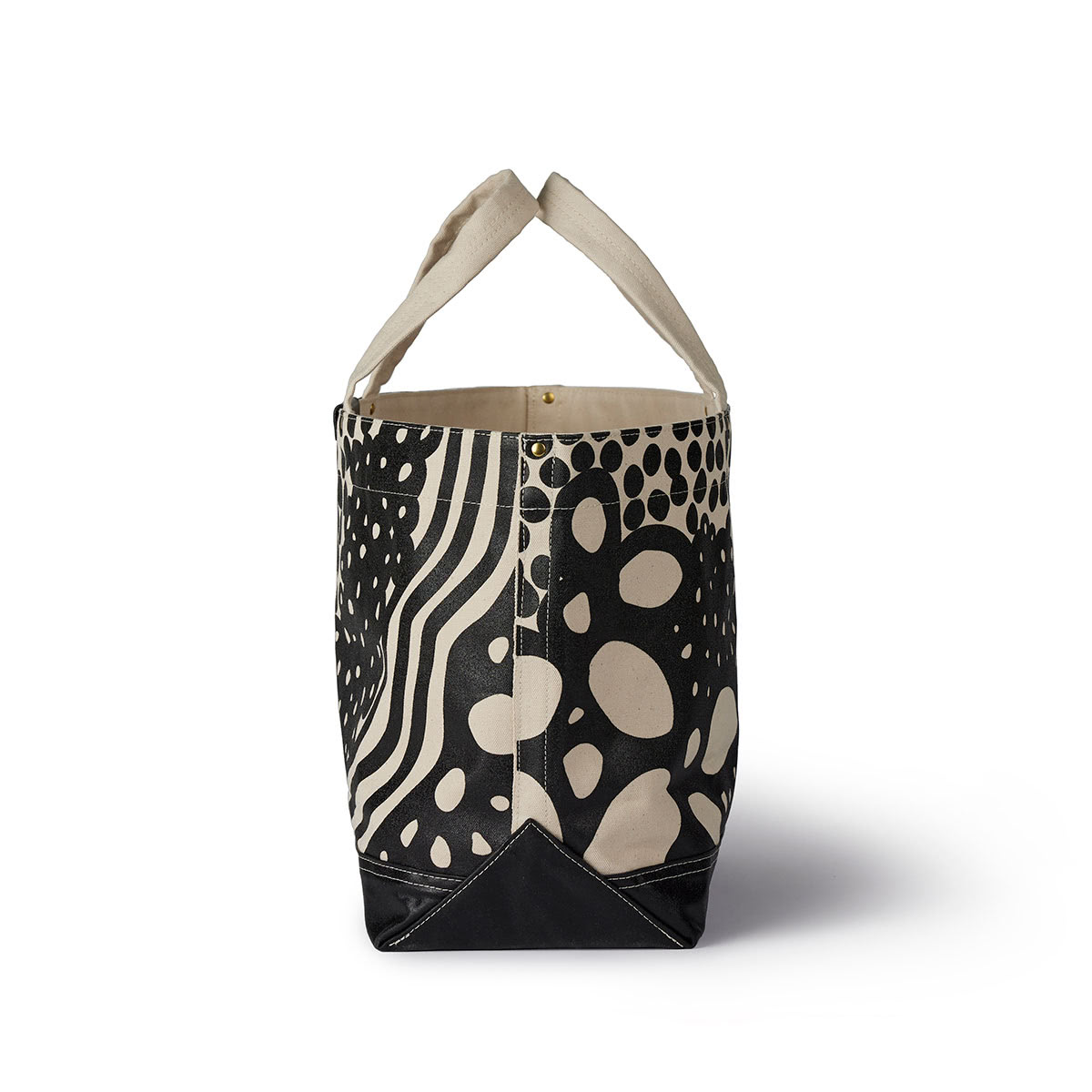 Side profile of Black and tan colored tote by Angela Adams
