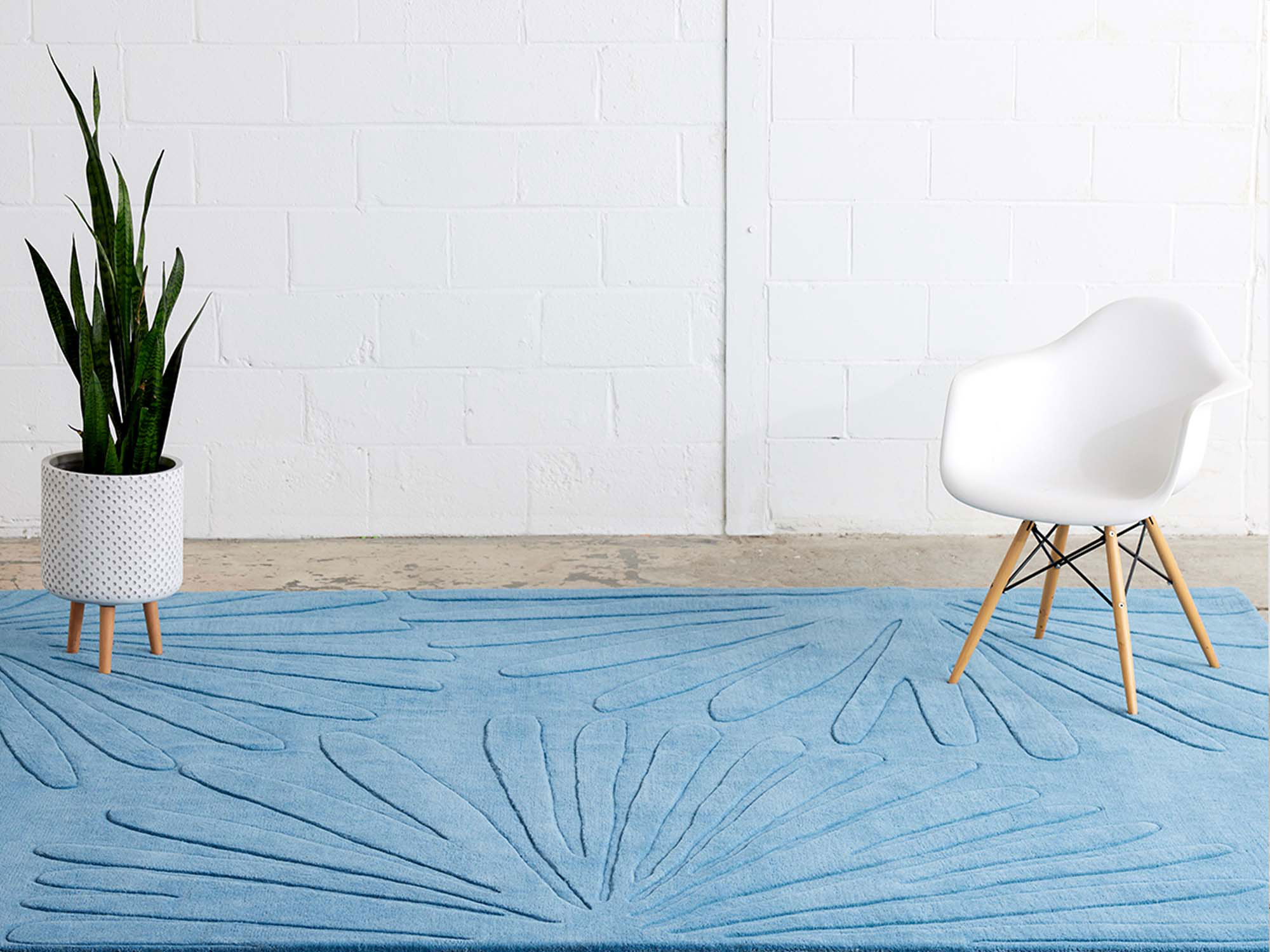 A soft blue, area rug with a flower raised pattern called Daisies Sky