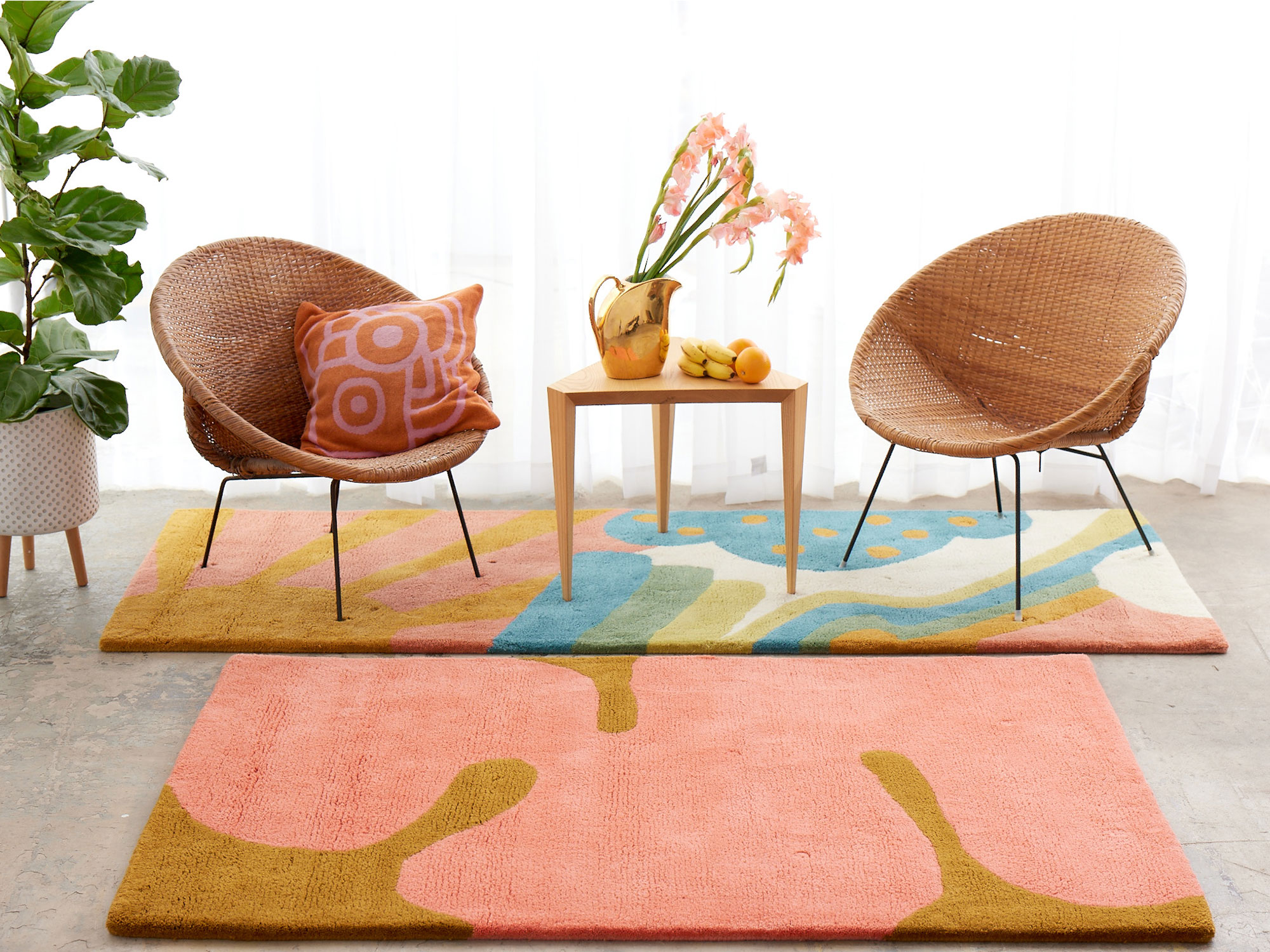 A bright and sunny room with colorful, modern rugs on the floor by Angela Adams