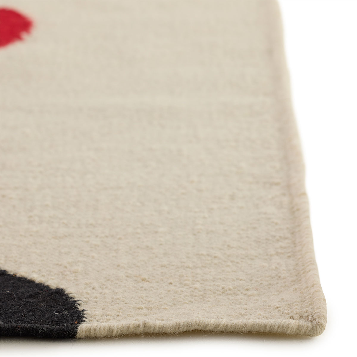 The corner detail of an abstract square red heart, and beige background rug named Love Blossom Crush.