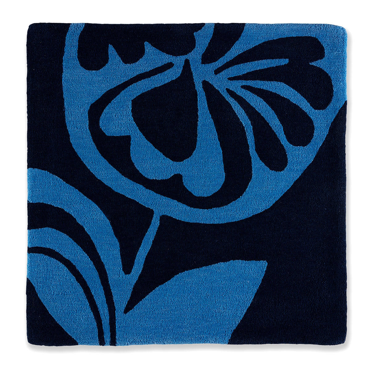 An abstract blue flower pattern on a square rug.