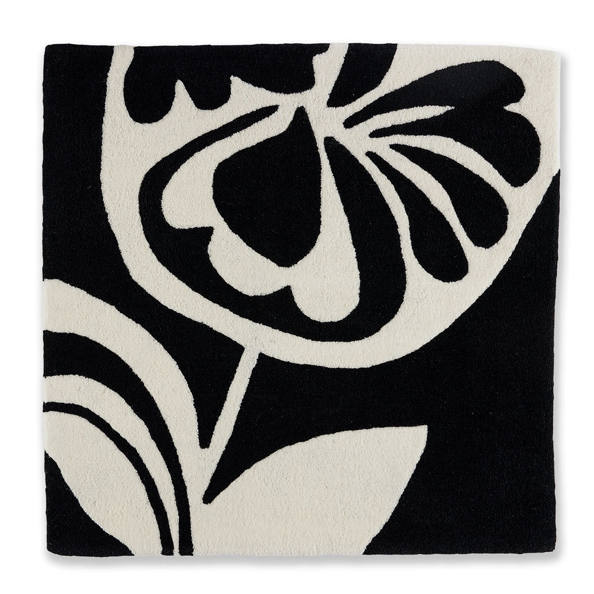 An abstract black and white flower pattern on a square rug.