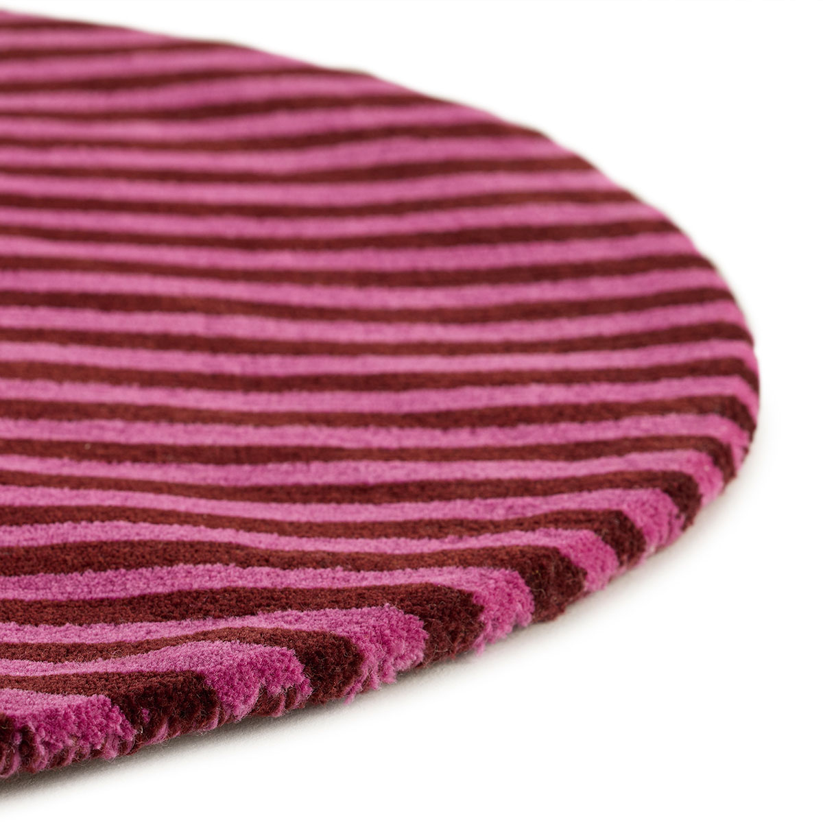 The corner of an abstract circle, pink and red rug named Punk Vivienne.