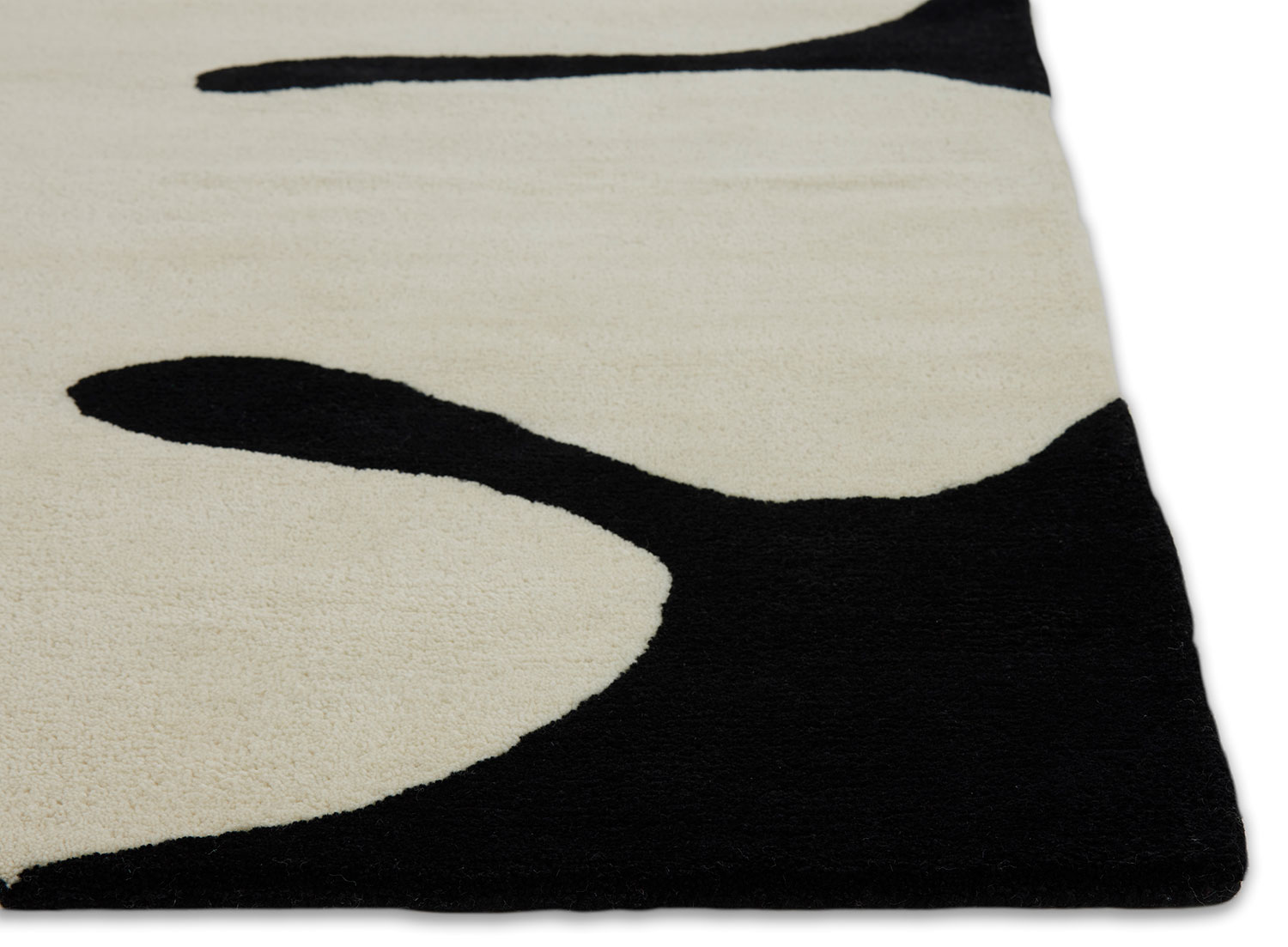 A detail of Astrud Coconut area rug by Angela Adams