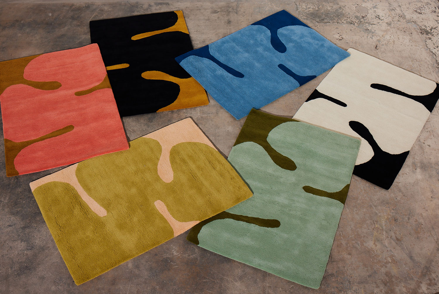 The color ways of Astrud rugs by Angela Adams on a floor