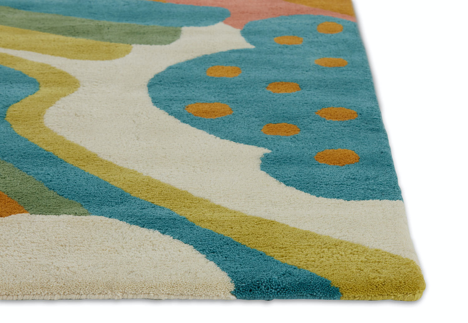A detail corner of a multi-colored, modern area rug by Angela Adams called Daytrip Happy