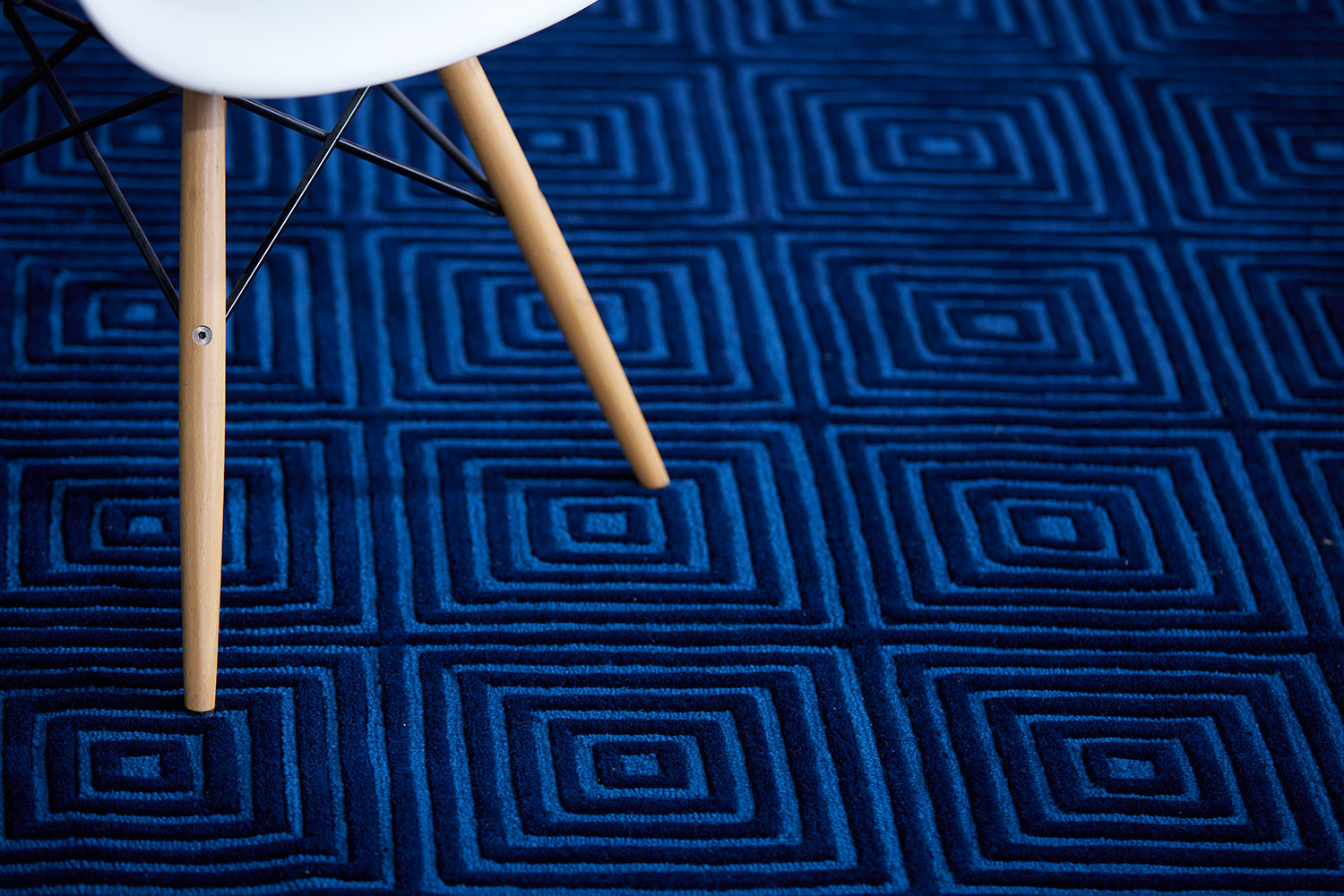 A deep blue, modern area rug called Duke Blue by Angela Adams