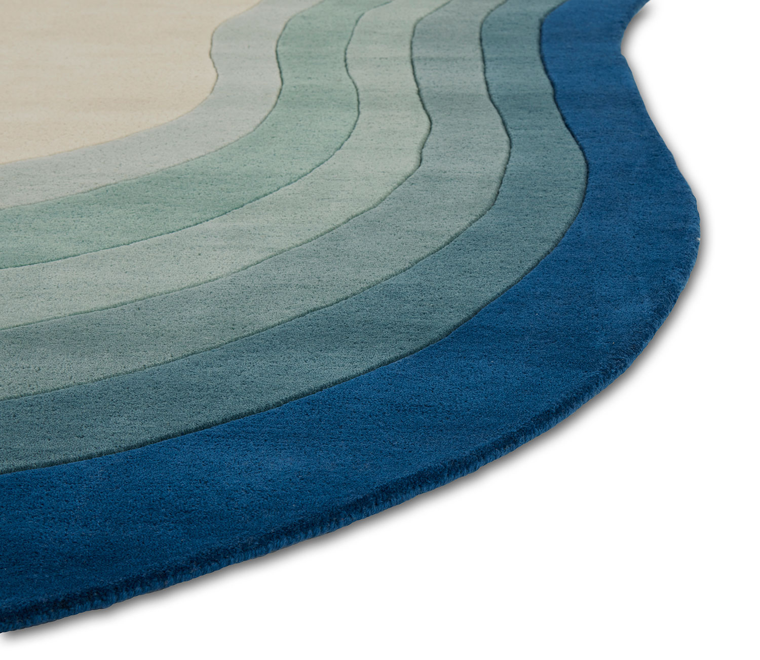 A corner of a blue gradient area rug called Pool Dream