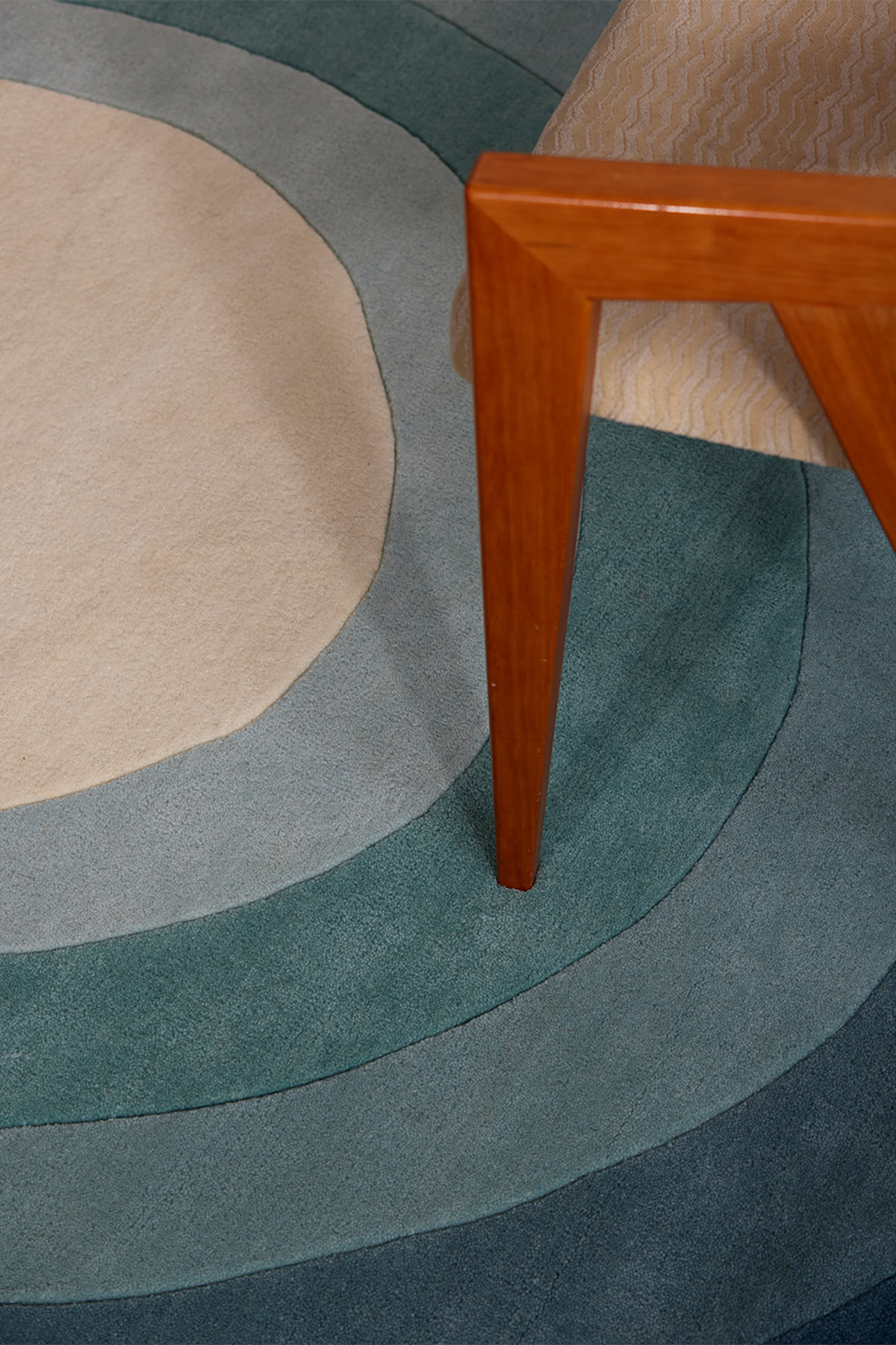 A close up of a blue gradient area rug called Pool Dream in the shape of a pool