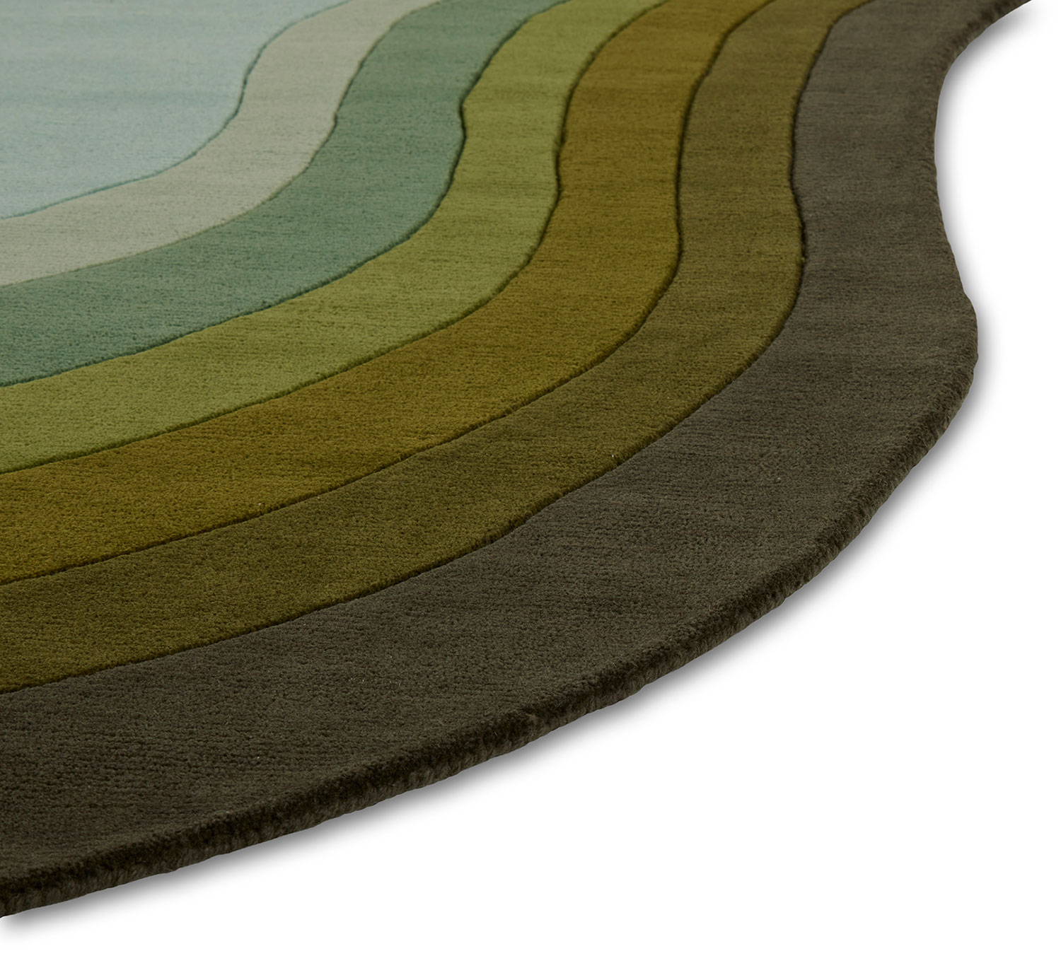 A close up of a green gradient area rug called Pool Woodland in the shape of a pool
