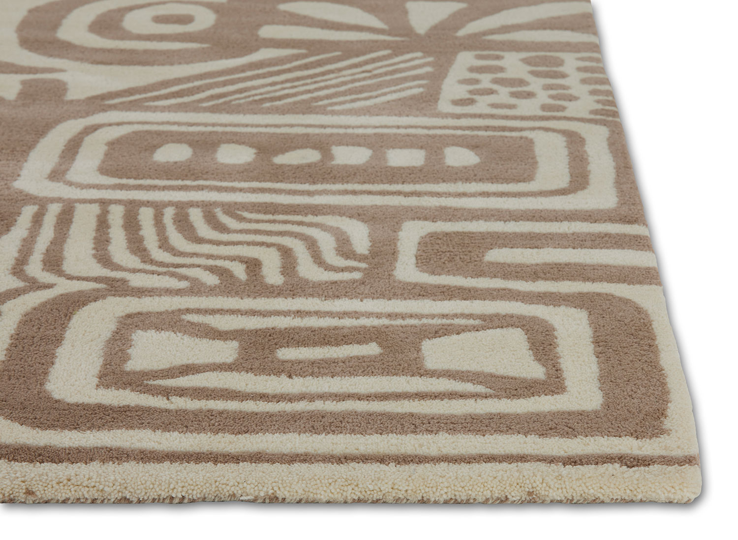 The corner detail of a neutral colored, modern area rug called Storybook by Angela Adams