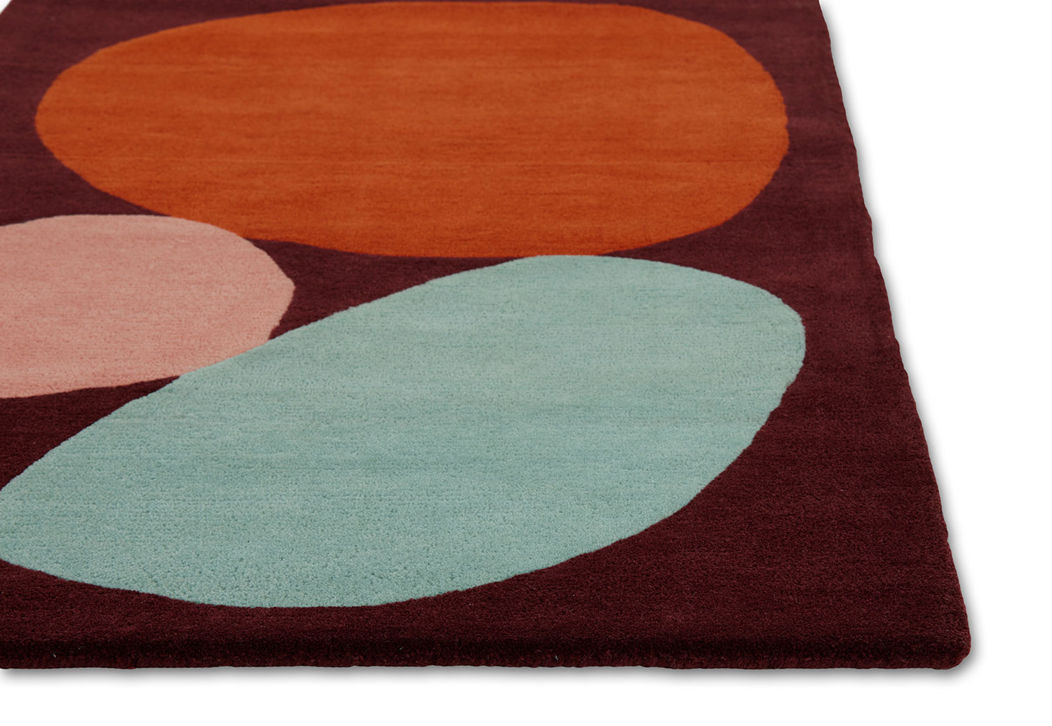 A corner of a modern rug called Three Stones Rust