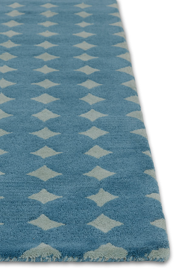 A close up corner of a blue area rug called Bongo Pool