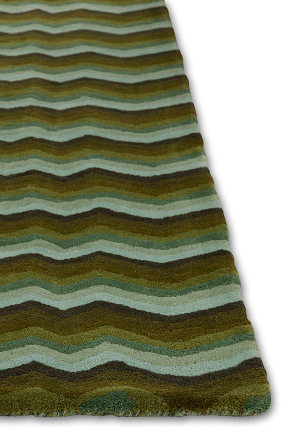 A detail of a modern area rug in green tones called Buzz Emerald