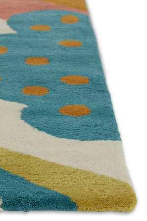 A corner of a multi-colored, modern area rug by Angela Adams called Daytrip Happy