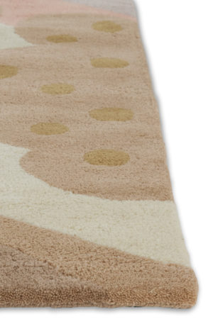 A corner of a cream colored, modern area rug by Angela Adams called Daytrip Lovely