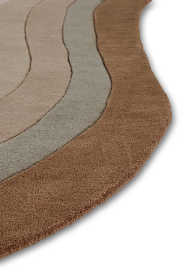 A close up of a neutral gradient area rug called Pool Heaven in the shape of a pool