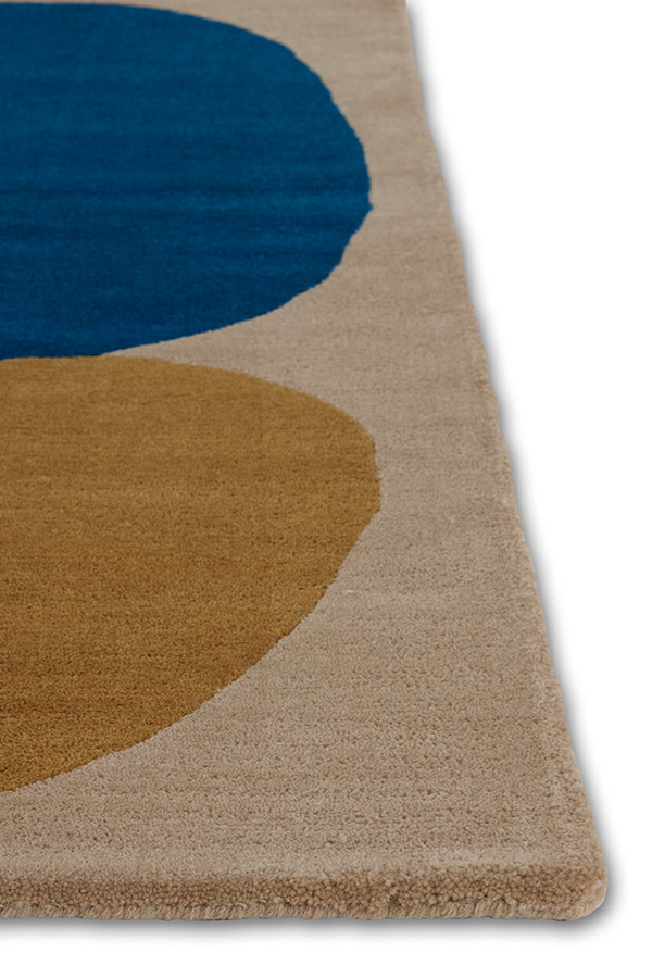 A corner of a modern rug called Three Stones Sand