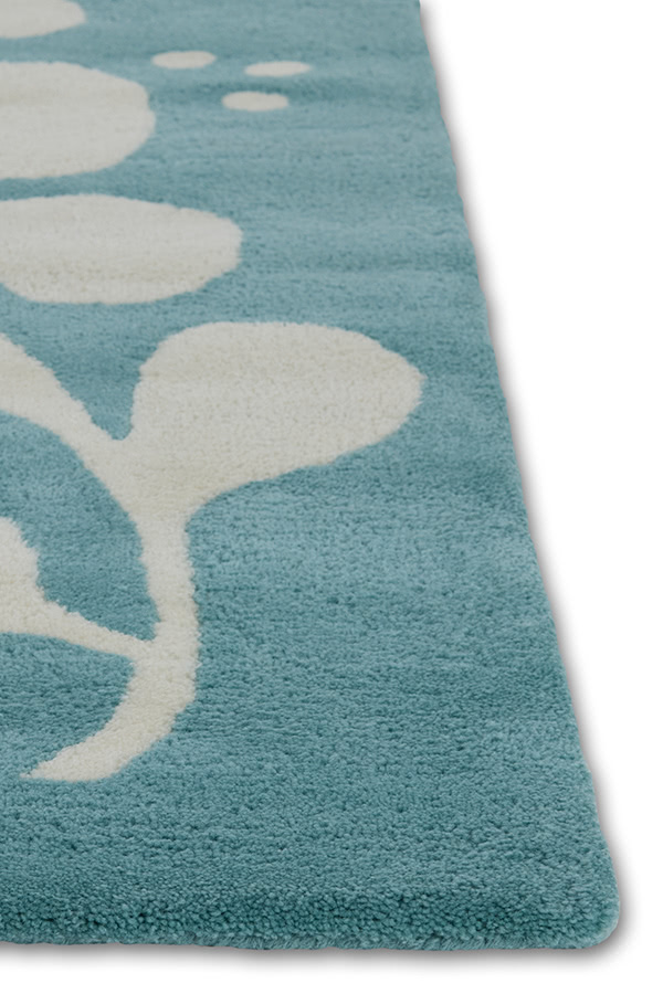 A neutral and blue area rug with abstract designs on it called Vine Hush