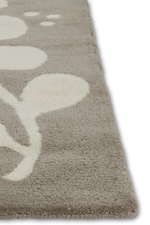 A neutral and gray area rug with abstract designs on it called Vine Swoosh