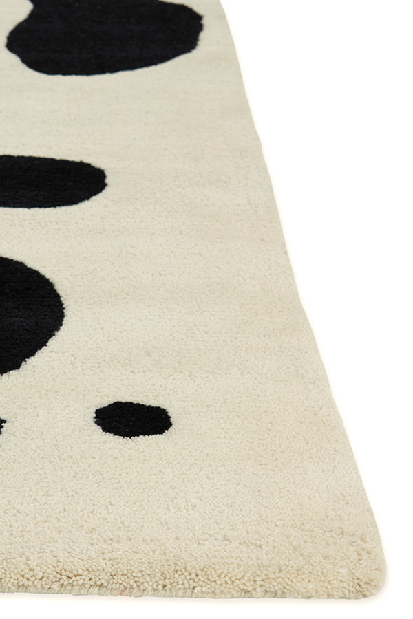 A neutral and black area rug with abstract designs on it called Vine Tango